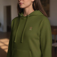 Close-up of olive green Raising Legends hoodie showing embroidered crown and RL logo on the front chest.