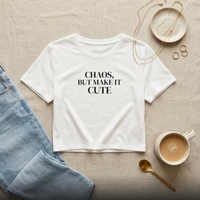 White “Chaos, But Make It Cute” cropped graphic t-shirt flat lay styled with denim and neutral accessories