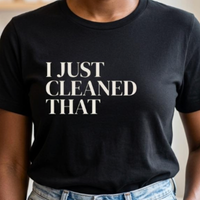 Close-up of black “I Just Cleaned That” graphic t-shirt showing bold typography and print detail