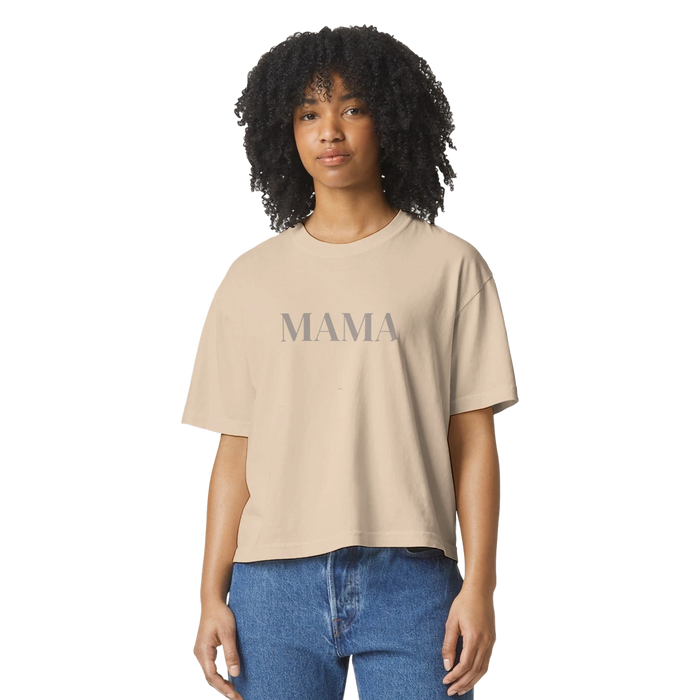 Model wearing ivory MAMA cropped tee styled casually with denim