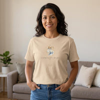 Latina woman wearing Capricorn Mama ivory zodiac graphic t-shirt standing indoors with hands in pockets