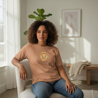 Load image into Gallery viewer, Woman of color modeling sandstone Leo Mama zodiac shirt with golden lion illustration in a soft natural light home setting