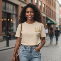 Woman wearing a 'Cool Moms Club' t-shirt on a city street.