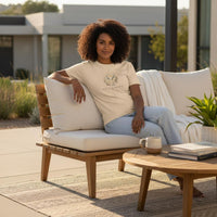 Taurus Mama ivory zodiac graphic t-shirt worn outdoors by woman sitting on patio sofa in natural sunlight