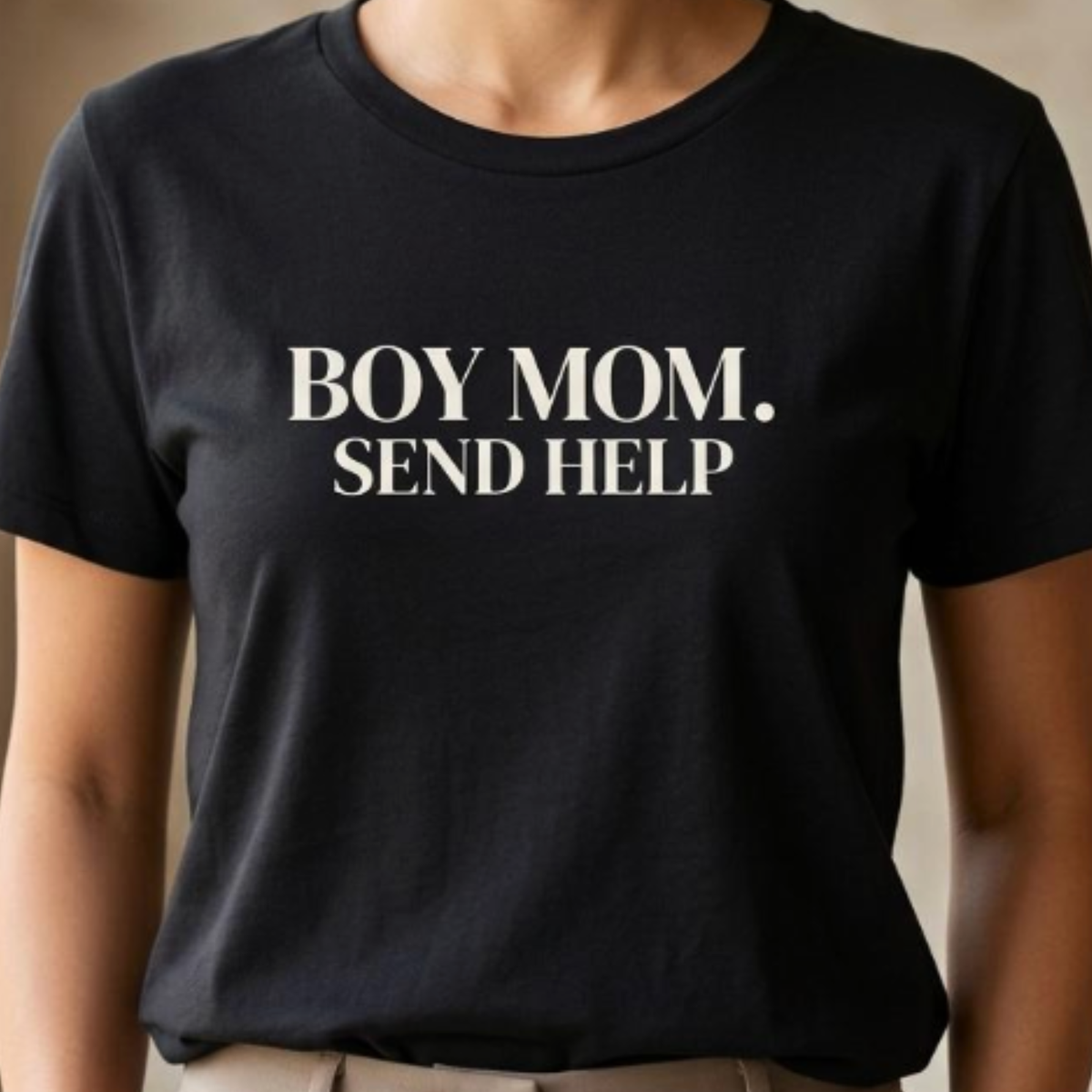 Close-up of black “Boy Mom. Send Help” graphic t-shirt showing bold typography and print detail