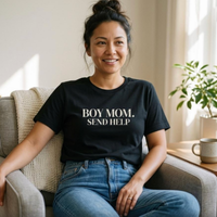 Black “Boy Mom. Send Help” graphic t-shirt on woman sitting on chair, casual mom lifestyle outfit, soft natural lighting
