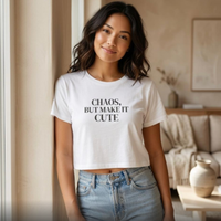 Woman wearing white “Chaos, But Make It Cute” cropped graphic t-shirt, relaxed indoor lifestyle outfit