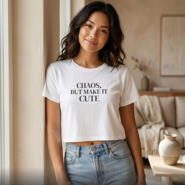 Woman wearing white “Chaos, But Make It Cute” cropped graphic t-shirt, relaxed indoor lifestyle outfit