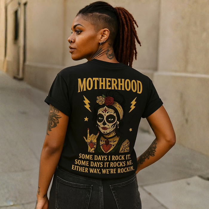 Woman wearing a black t-shirt with a graphic design and text on the back.