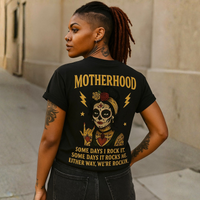 Load image into Gallery viewer, Woman wearing a black t-shirt with a graphic design and text on the back.