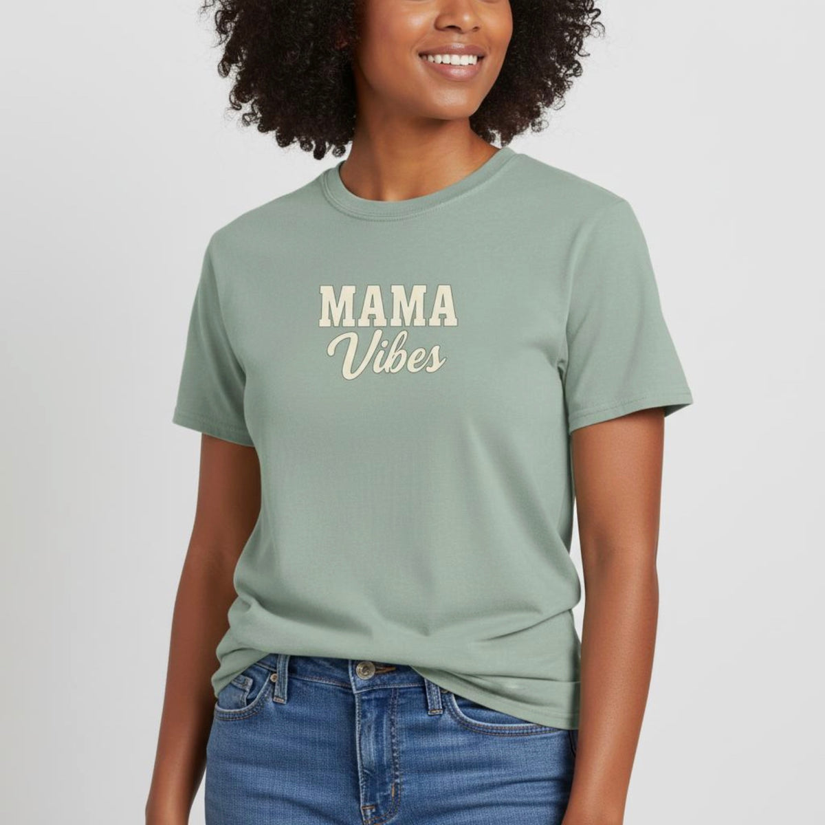 Woman wearing a green t-shirt with 'MAMA Vibes' text on a plain background