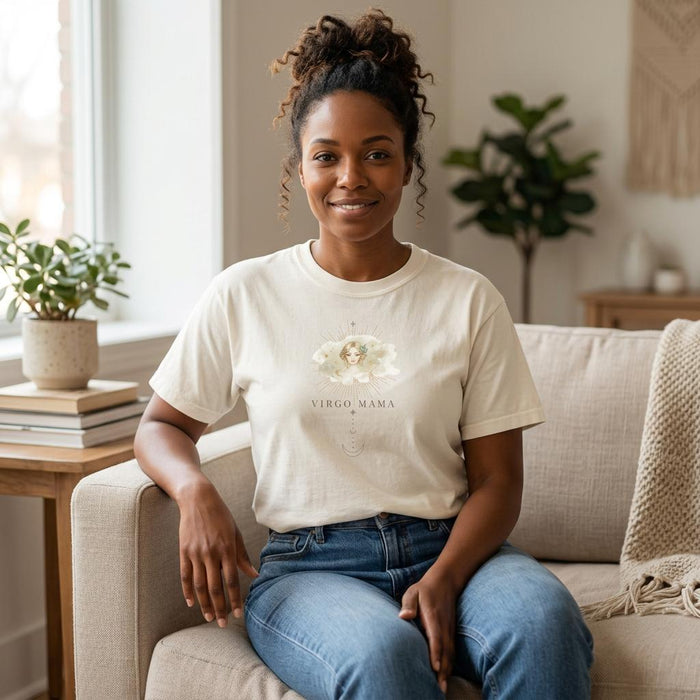 Woman of color wearing Virgo Mama ivory zodiac mom t-shirt seated indoors in neutral living room