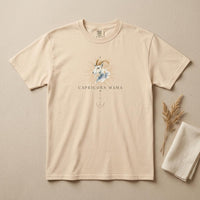 Capricorn Mama ivory zodiac graphic t-shirt laid flat on neutral background