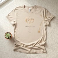 Flat lay of ivory Aries Mama zodiac t-shirt with printed watercolor ram design on neutral background