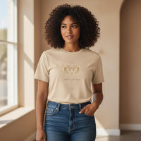 Woman modeling ivory Aries Mama zodiac t-shirt with watercolor ram chest design indoors